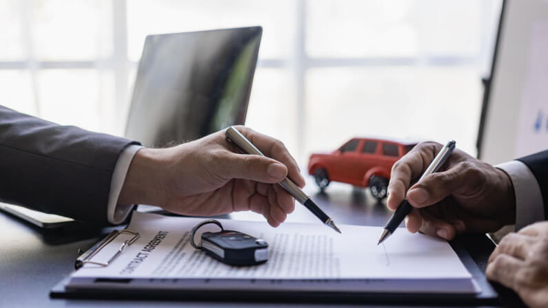 The car dealership allows customers to sign car insurance documents or rental paper. Planning to manage transportation finance costs The concept of car insurance and new car loan business